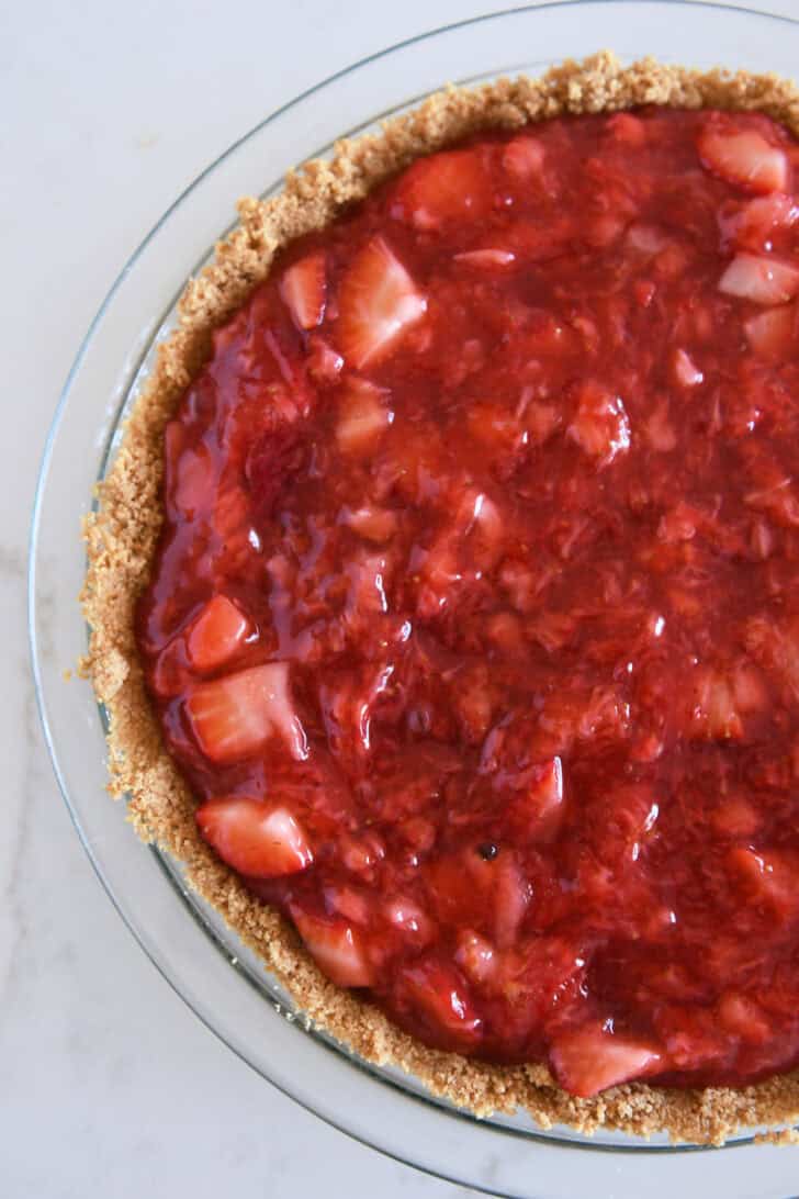Thick strawberry cooked mixture spread into graham cracker pie crust.