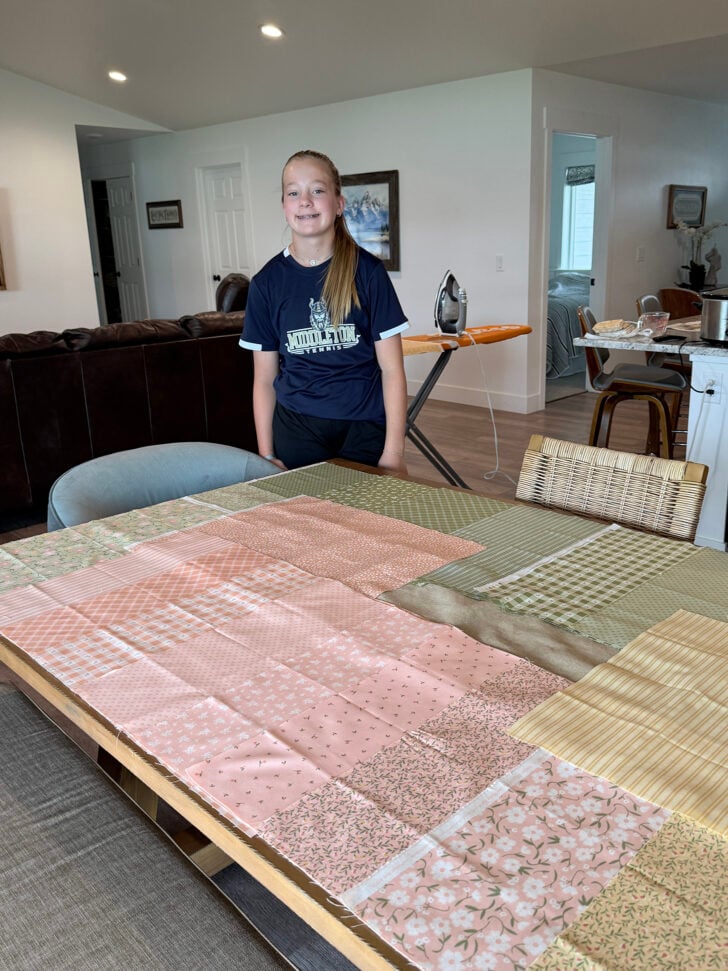 Young teenage girl working on quilt.