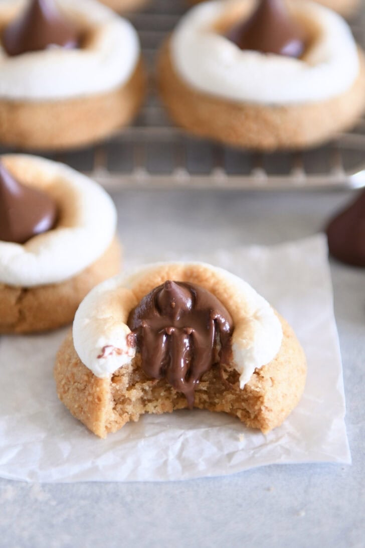 Bite taken out of s'mores Hershey Kiss blossom cookie.