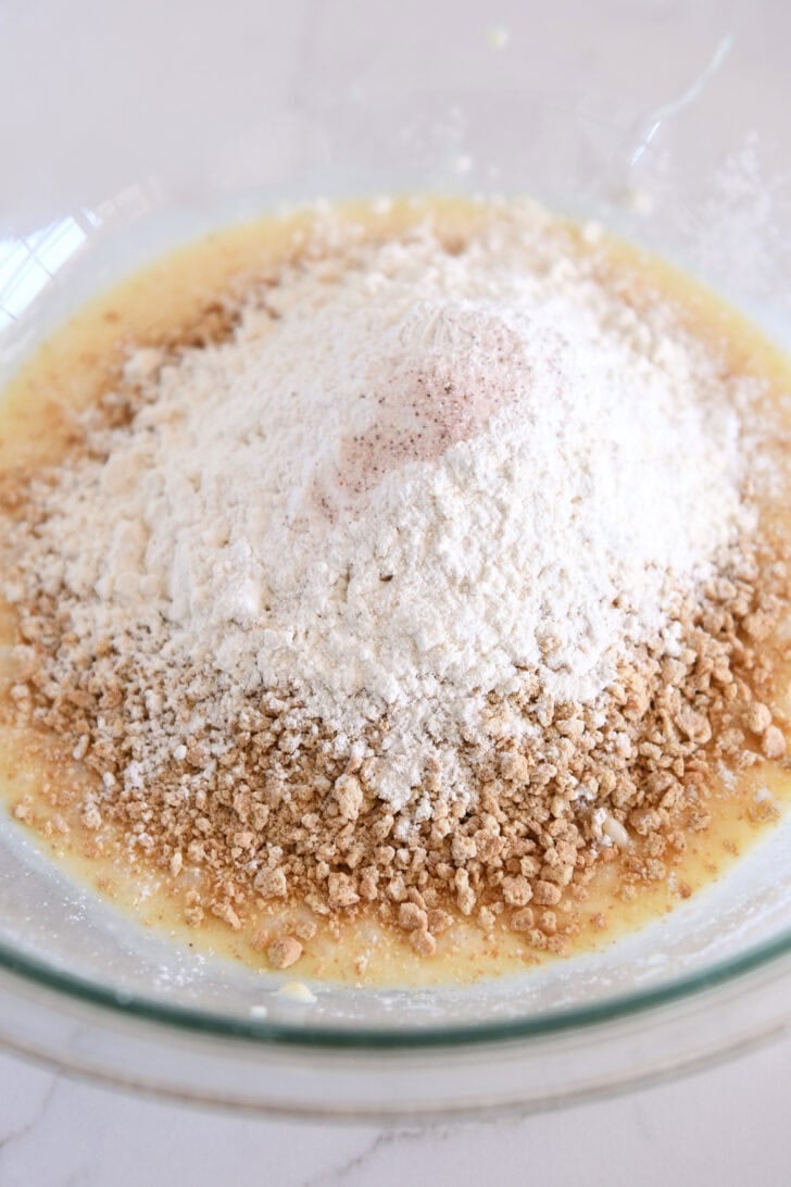 Glass bowl with sweetened condensed milk, graham cracker crumbs and flour.