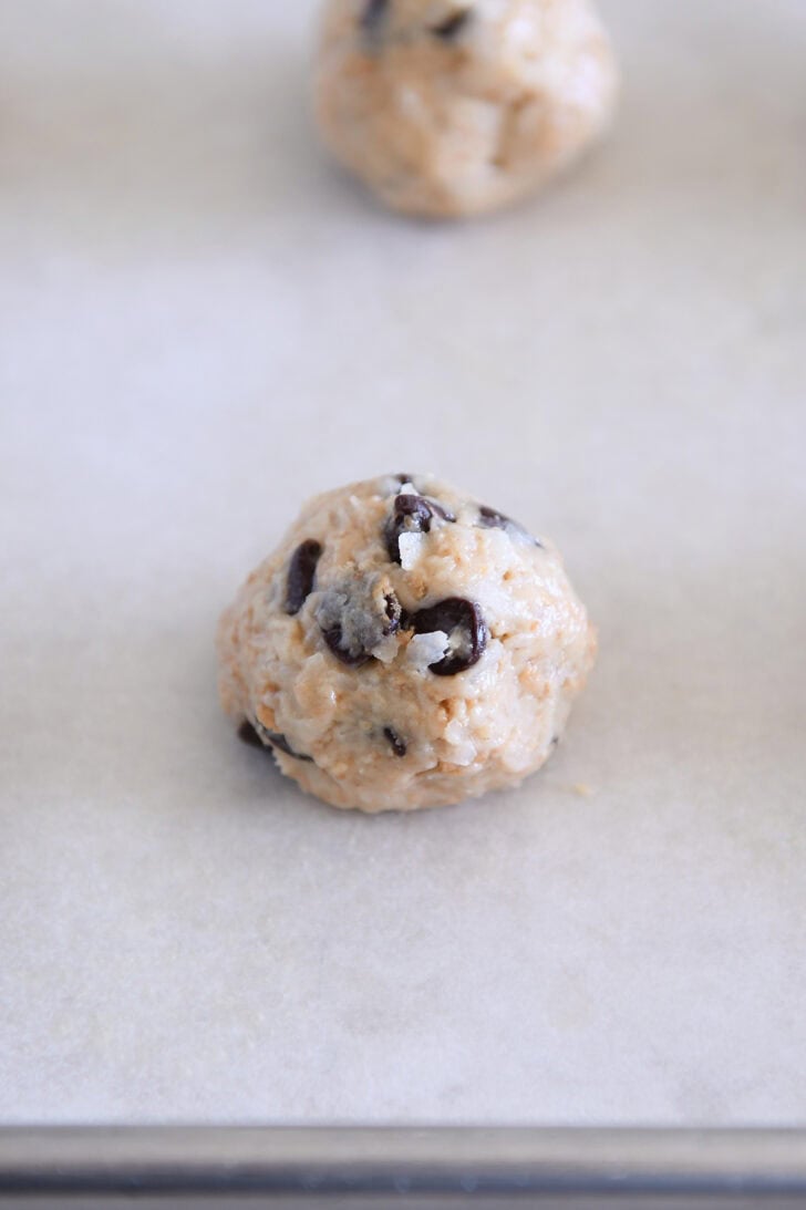 Cookie dough ball on parchment paper.