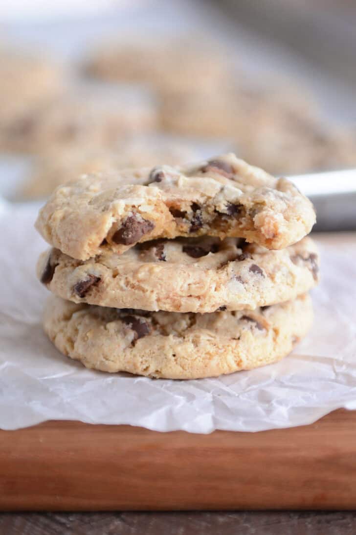 Bite taken out of top chocolate chip treasure cookie on stack of cookies.
