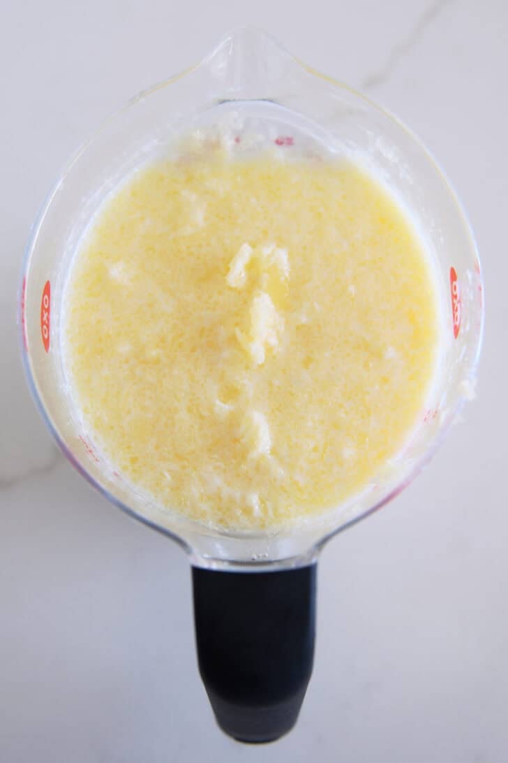 Melted butter mixed with milk until chunky in liquid measuring cup.
