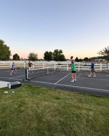 Playing pickleball outside.