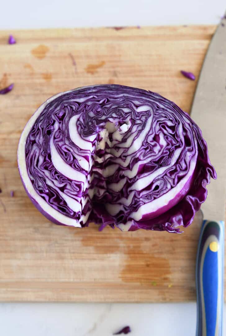 Red cabbage cut in half with core removed.