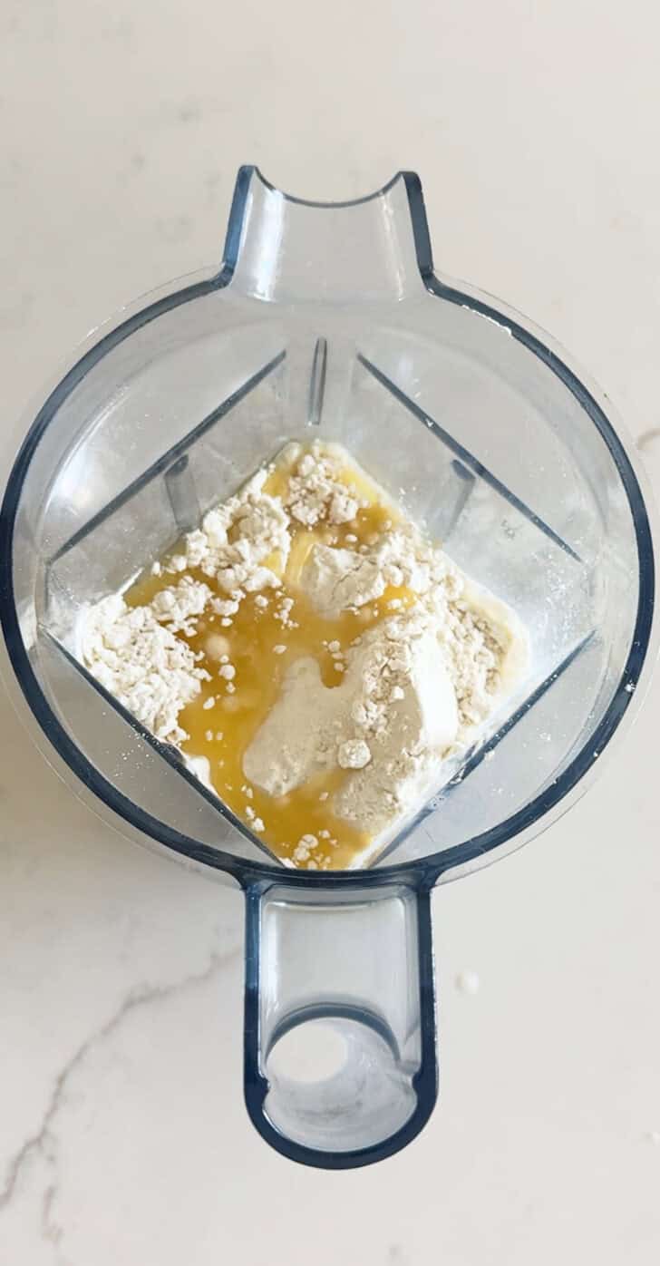 Melted butter in blender with flour, milk and eggs.