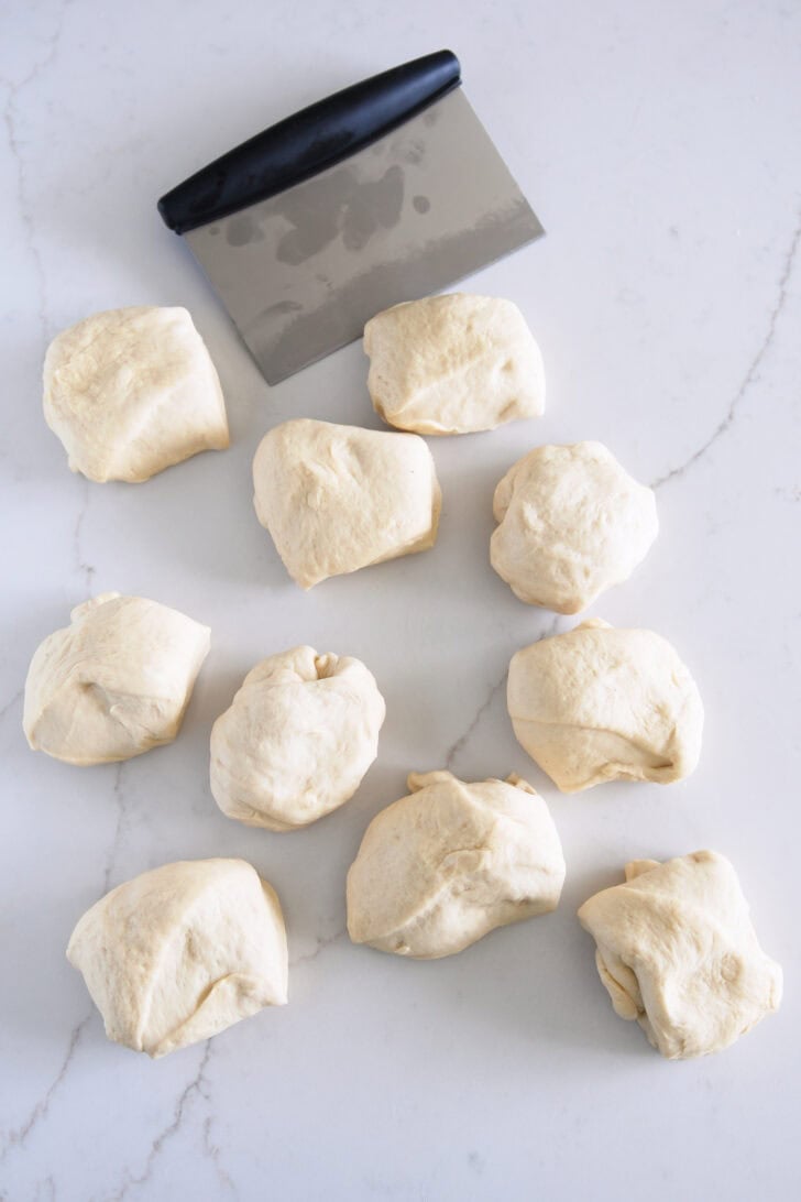 Dough cut into eight pieces with bench scraper.