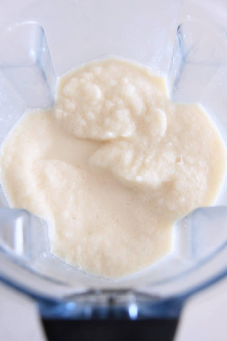 Blender with blended up mixture of ice, pineapple juice, half-and-half and cream of coconut.