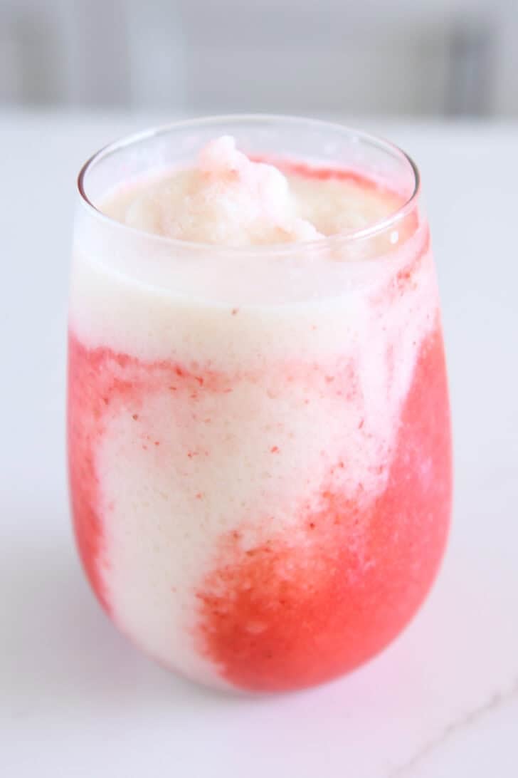 Glass cup filled with mixture for lava flow drink.