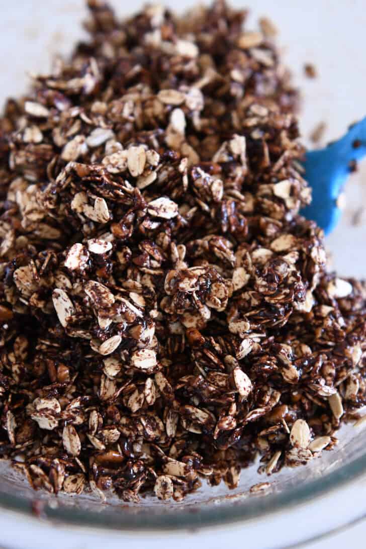 Chocolate granola ingredients in glass bowl.