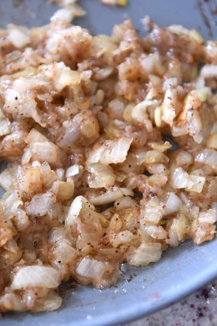 A skillet full of sautéed onions.