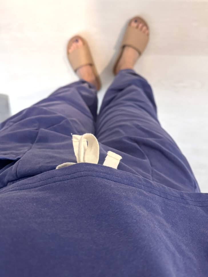 Purple sweat suit set and tan slides.