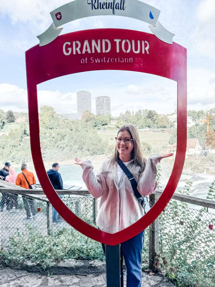 Mel standing in front of Rhine falls sign.