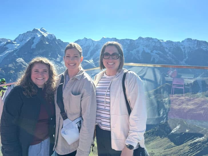 Three women standing at the top of Schilthorn.