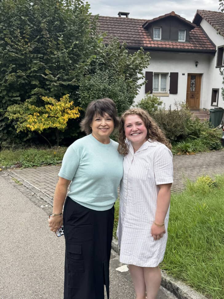 Two women standing in front of Swiss home.