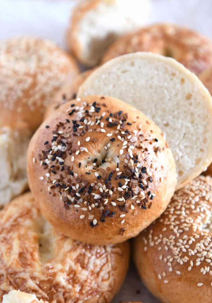 Everything bagel topped baked sourdough bagel cut in half.