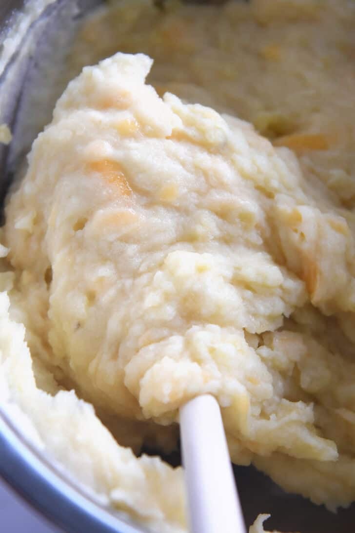 Top down view of an Instant Pot full of cheesy mashed potatoes.