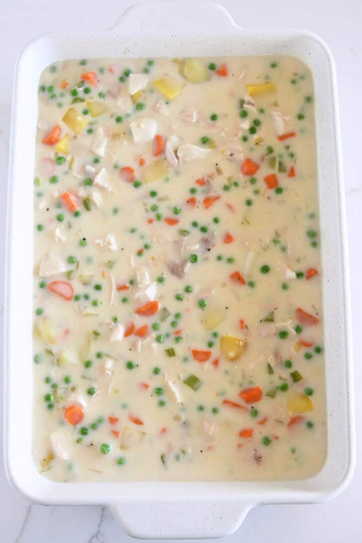 White 9X13-inch pan with chicken pot pie filling.