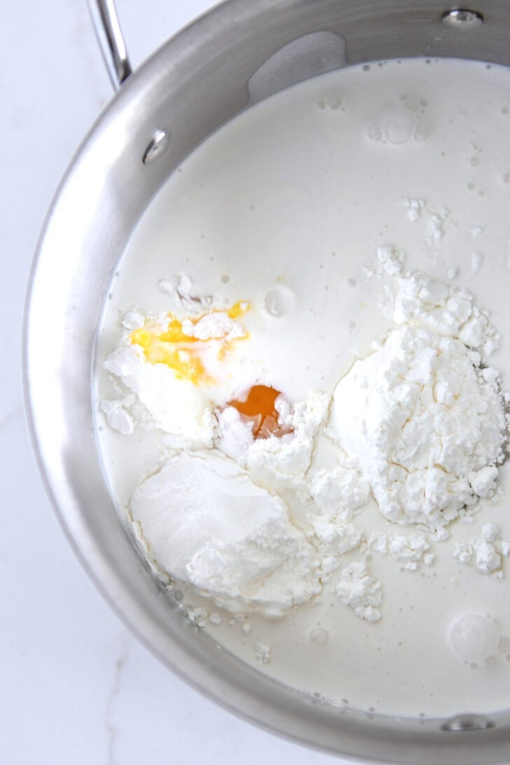 Stainless pot with cornstarch, sugar, egg yolk and milk.