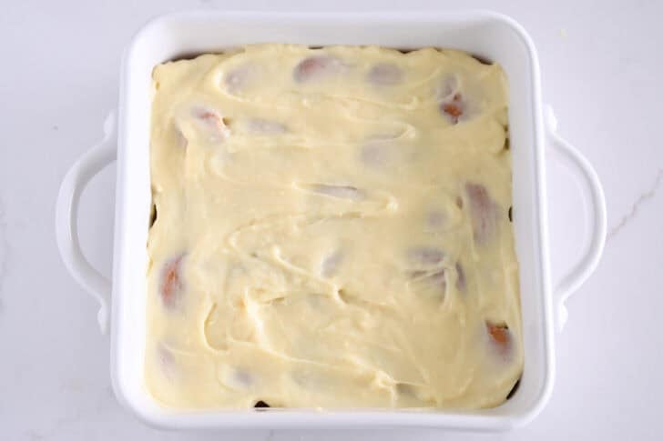 White square 8X8 baking dish with vanilla pudding layered over nilla wafers.