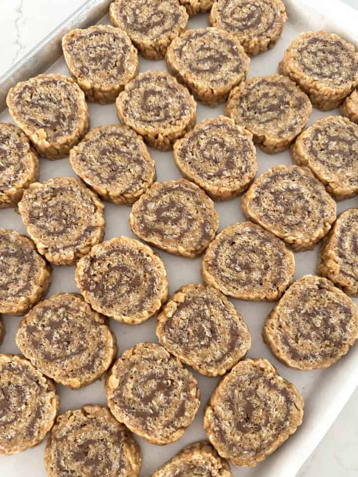 Dozens of scotcheroos pinwheels on parchment paper.