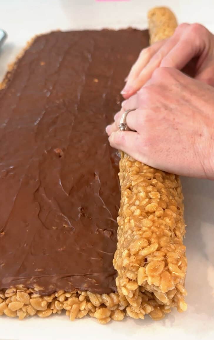 Rolling scotcheroo pinwheels up into a log.