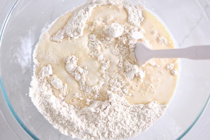 Glass bowl with flour and butter and hot water.