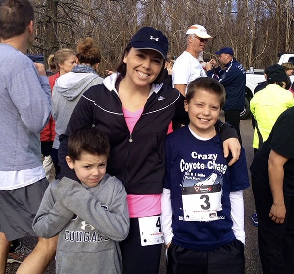 A woman standing with her two sons. 
