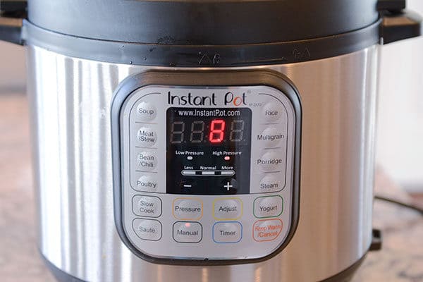 The front of an Instant Pot with 8 minutes left on the timer. 