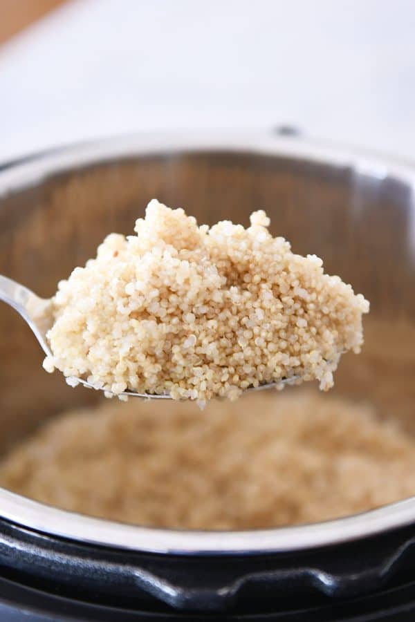 Spoonful of cooked quinoa in the Instant Pot.