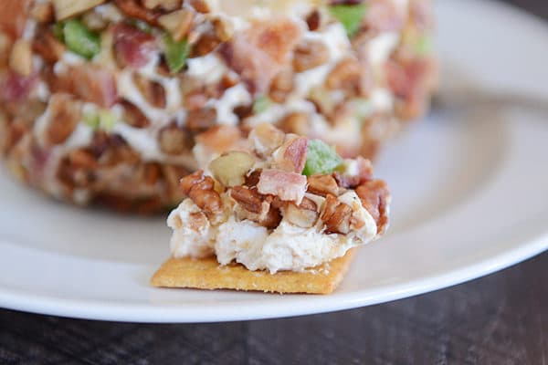 A cracker with a bacon cream cheese dip on top.