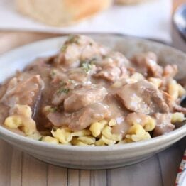 Bowl of slow cooker beef stroganoff over spaetzle.