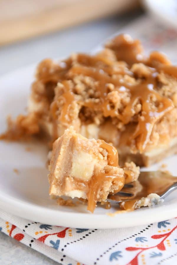 Forkful bite of caramel apple cheesecake bar.