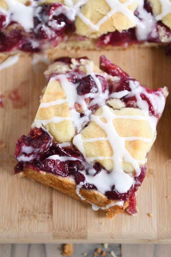 Cherry pie cookie bar on wood cutting board.