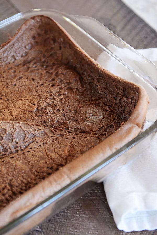 A glass 9x13 with a cooked chocolate dutch baby pancake.