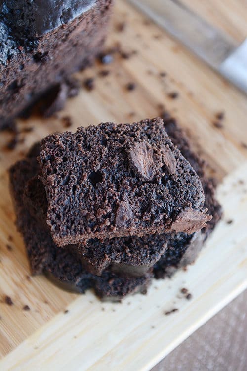 Slices of chocolate quick bread stacked on top of each other.
