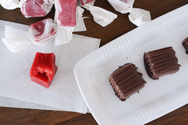 Top view of chocolate dipped caramels and cinnamon caramels.