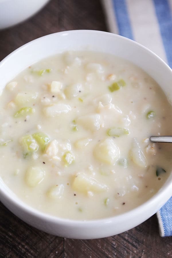 Top view of a bowl of creamy vegetable filled New England clam chowder.