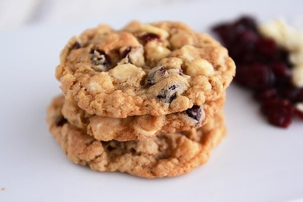 A stack of three white chocolate craisin cookies.