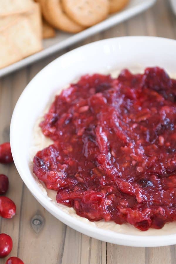 Cranberry pecan cream cheese dip in white bowl.