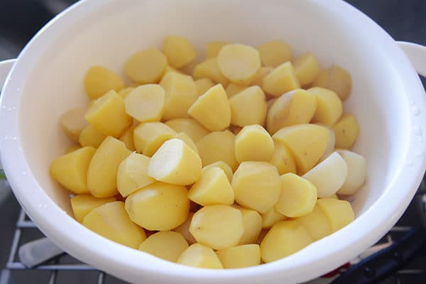 Large bowl of cooked mashed potatoes ready to be mashed. 