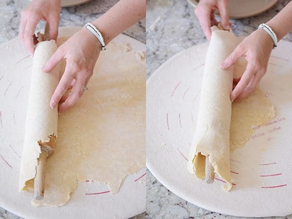 Pie crust getting rolled off of a rolling pin.