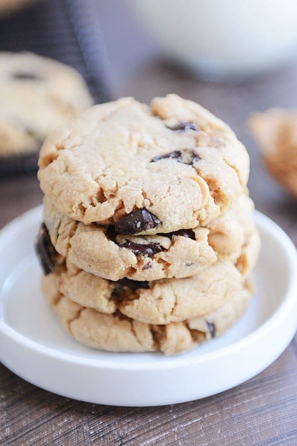 A stack of chocolate chip peanut butter cookies in a white ramekin.