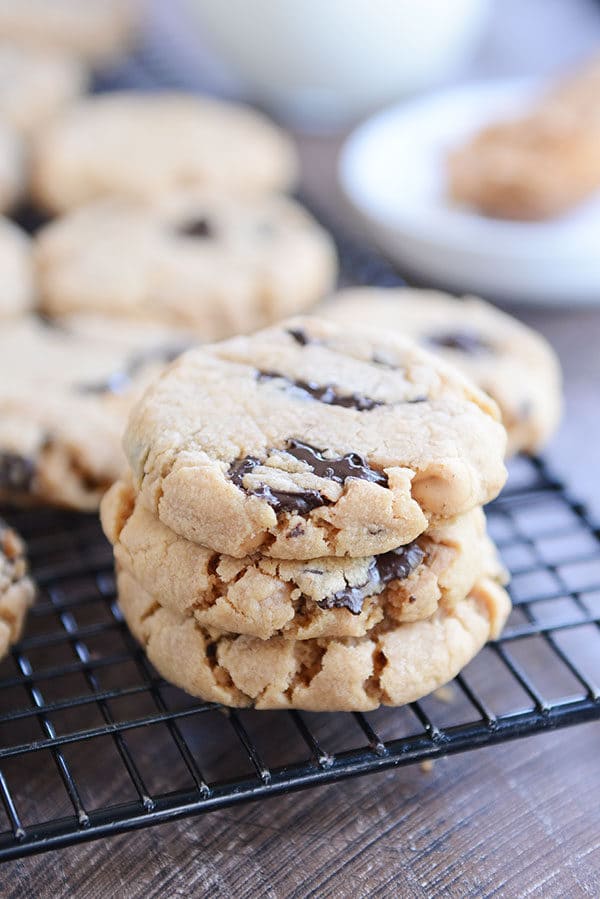 A stack of peanut butter chocolate chip cookies on a cooling rack. 