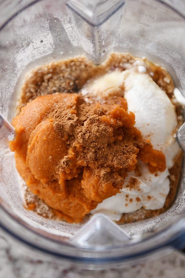 Ingredients for easy pumpkin blender muffins layered in Vitamix.