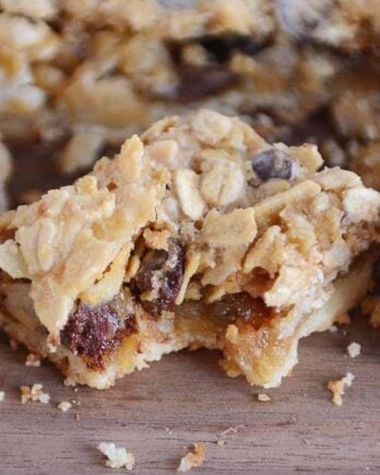 Bite taken out of caramel oat chocolate chunk shortbread bar.