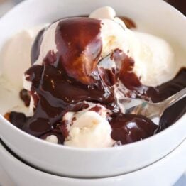 Vanilla ice cream in white bowl with 5-minute hot fudge sauce on top.