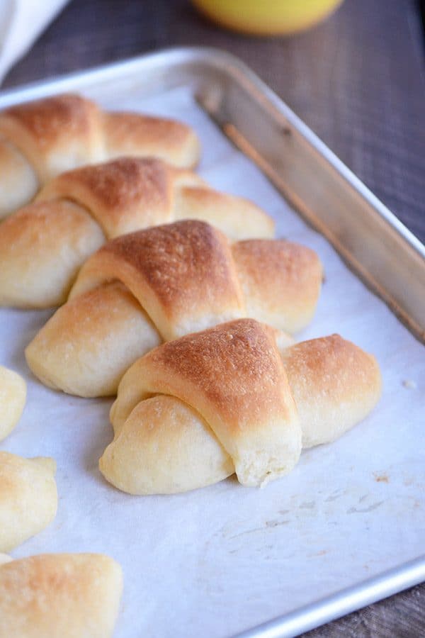 A cookie sheet of baked crescent rolls.