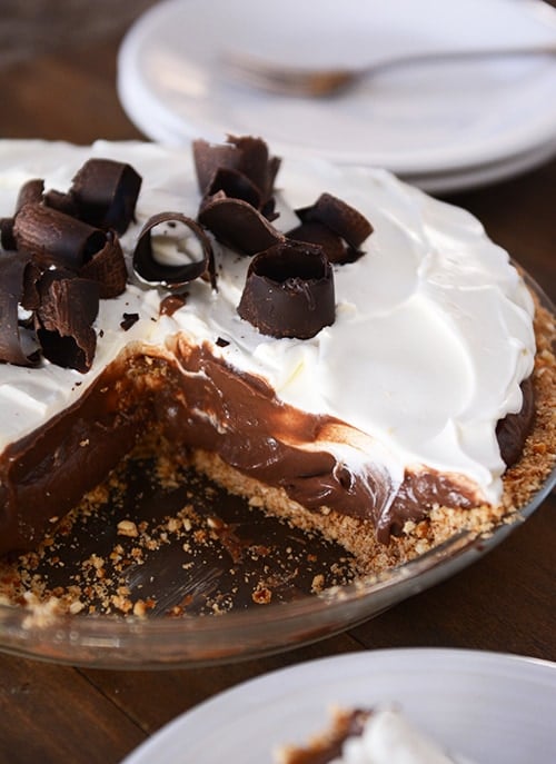 A chocolate pudding pie with a slice taken out.