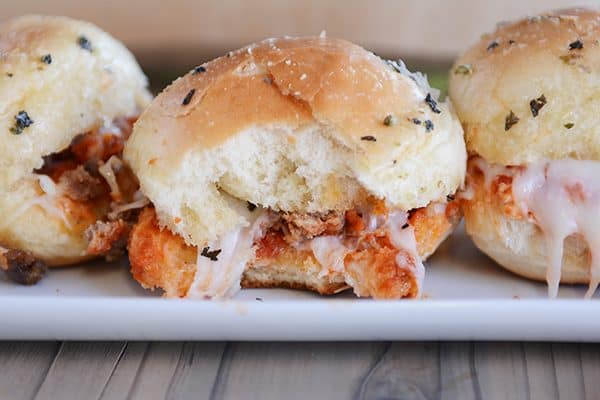 A pull-apart pizza slider with a bite taken out.